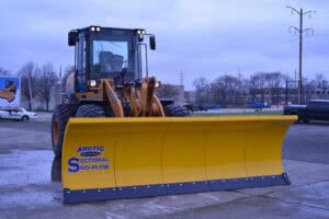 arctic snow and ice sectional snow plow on wheel loader