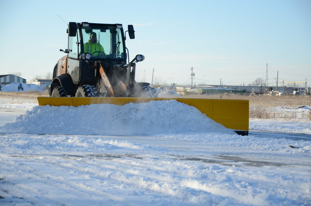 arctic snow and ice sectional snow plow plowing snow front