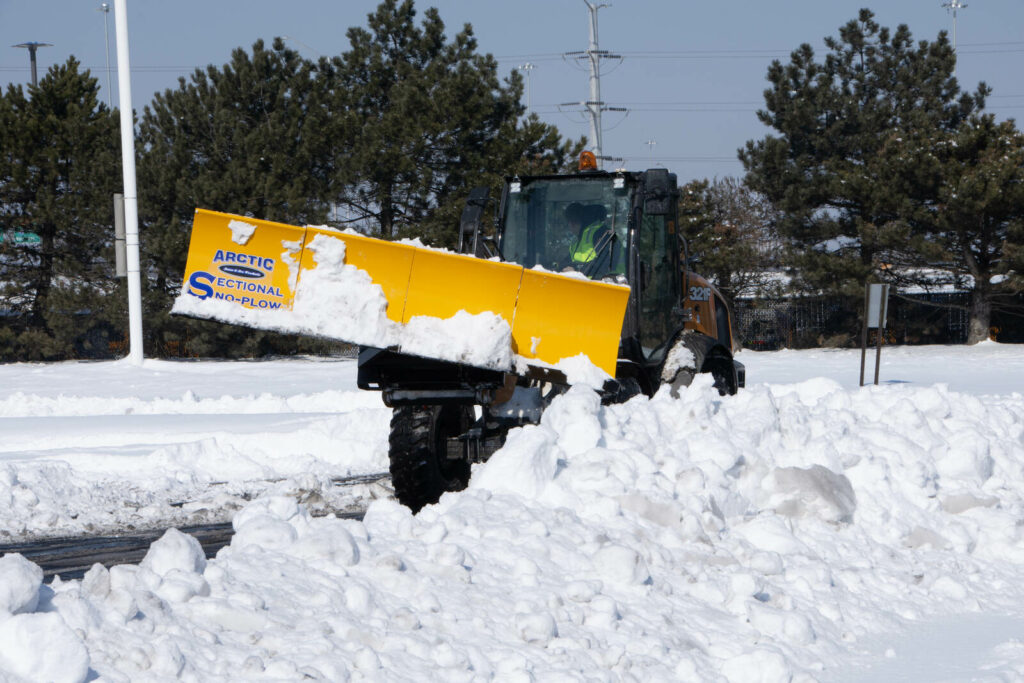 arctic snow and ice sectional snow plow plowing snow lift up copy