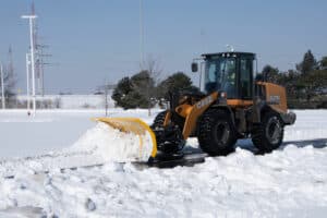 arctic snow and ice sectional snow plow plowing snow wheel loader copy