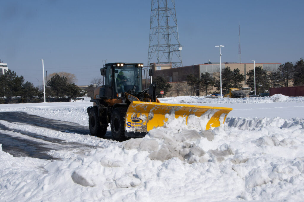 arctic sno-pusher on wheel loader with piles of snow in alberta (1)