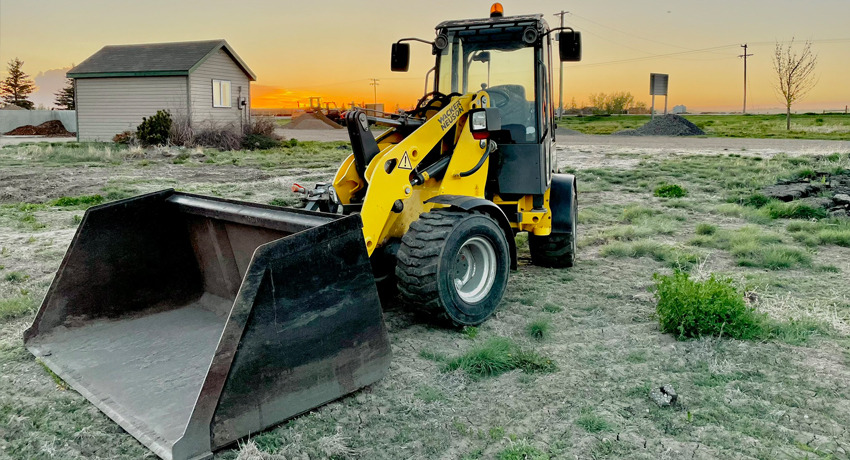 wheel-loader-with-attachment-in-field-in-western-canada-rentals