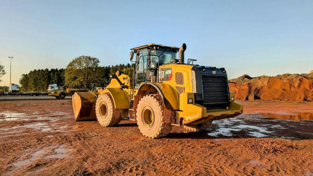 CAT 962M wheel loader on a construction site at sunset, provided by Plains Equipment Rentals, serving Western Canada with reliable heavy equipment rentals