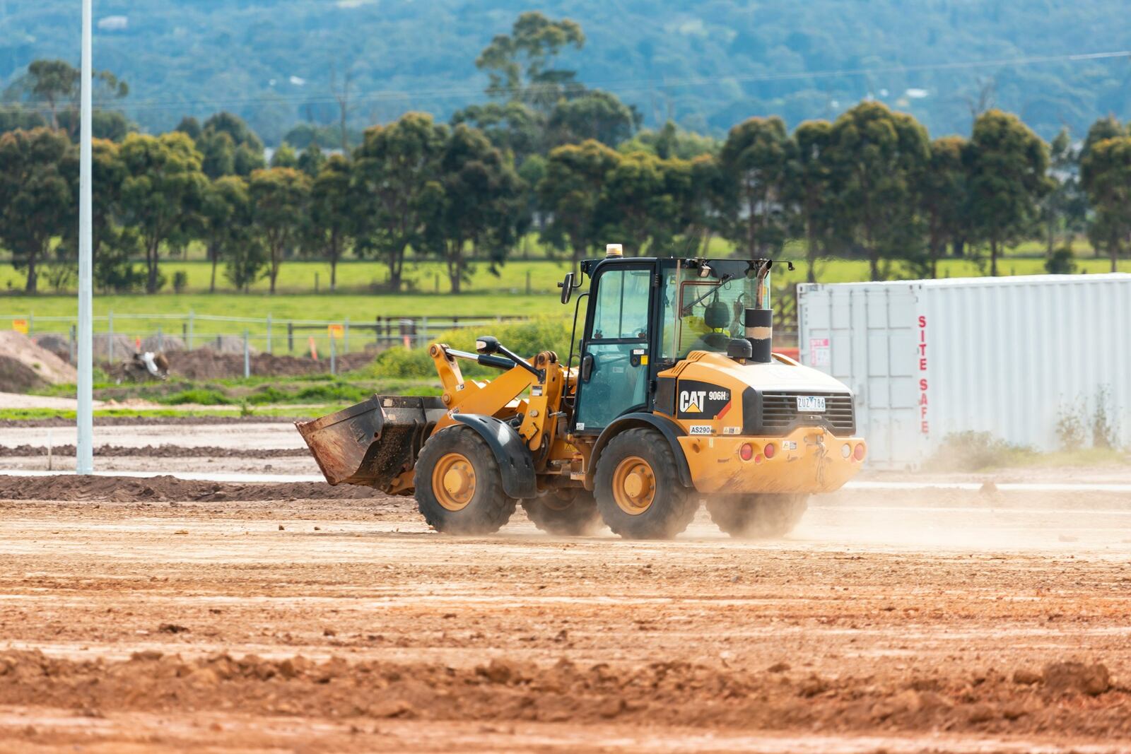 Caterpillar 906H2 wheel loader working on a construction site, offered by Plains Equipment Rentals in Western Canada