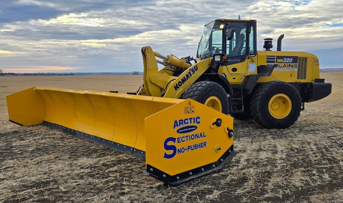 Komatsu WA320 loader with Arctic sectional snow pusher from Plains Equipment Rentals, available across Western Canada