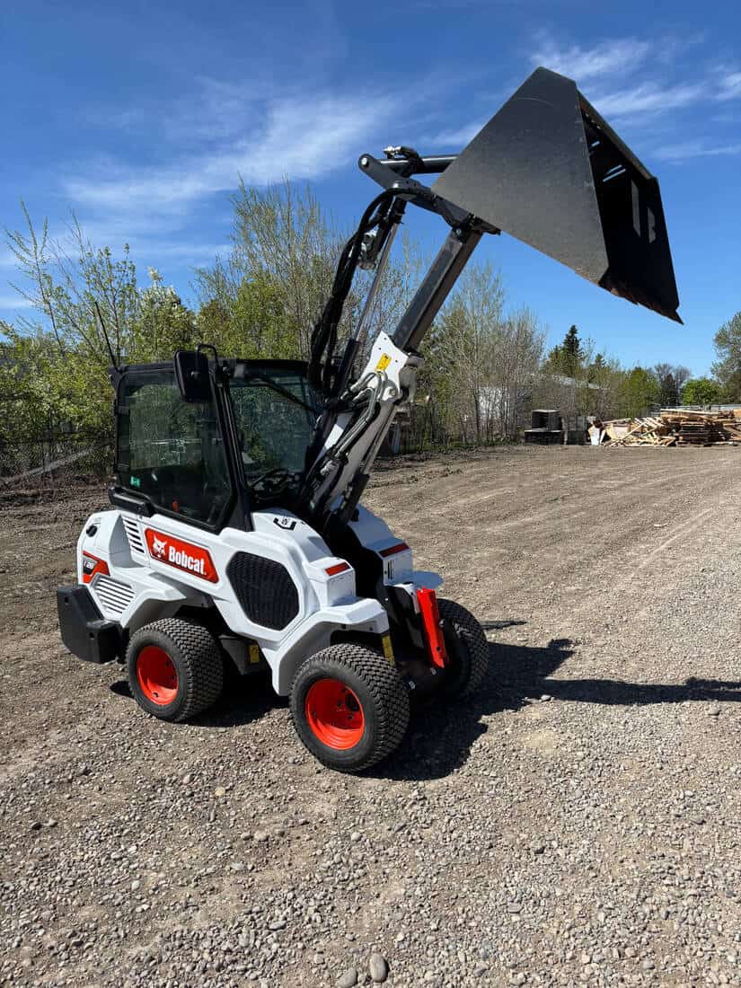 2022-bobcat-l28-loader-on-gravel-yard-articulated-bucket-raised-for-sale-western-canada