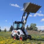 bobcat-l28-2022-loader-bucket-raised-field-of-flowers-for-sale-in-western-canada
