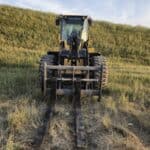 Front view of John Deere 524K-II loader with pallet forks, available for sale in Western Canada