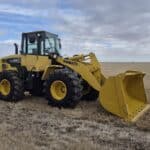 2010 Komatsu WA250-6 with front bucket at low angle showing bucket capacity
