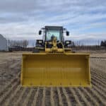 Front bucket view of 2010 Komatsu WA250-6 showing cutting edge and bucket width
