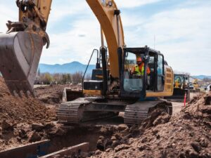 Excavator operator digging a trench on a Western Canada jobsite